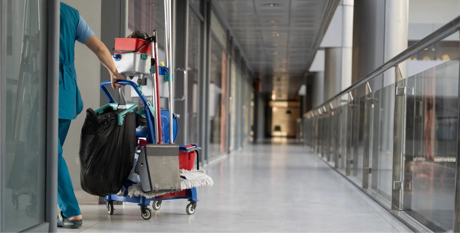 a woman pushing a mop in a hallway